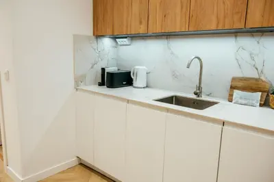 a kitchen with white cabinets and a sink at Sada Flat, Jacuzzi, Chill Out, 7 Pax, SmartTV in Valencia