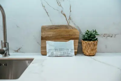 a kitchen counter with a sink and a box and a plant at Sada Flat, Jacuzzi, Chill Out, 7 Pax, SmartTV in Valencia