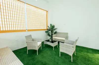 a room with chairs and a table and a plant at Sada Flat, Jacuzzi, Chill Out, 7 Pax, SmartTV in Valencia