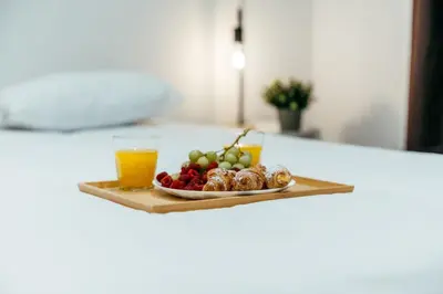 a plate of fruit and a glass of orange juice at Sada Flat, Jacuzzi, Chill Out, 7 Pax, SmartTV in Valencia