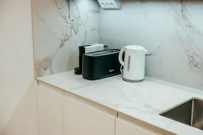a kitchen counter with a coffee maker and a toaster at Sada Flat, Jacuzzi, Chill Out, 7 Pax, SmartTV in Valencia