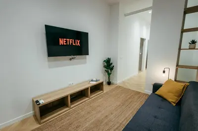 a living room with a couch and a tv on a wall at Sada Flat, Jacuzzi, Chill Out, 7 Pax, SmartTV in Valencia