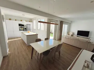 a kitchen and living room with a table and chairs at Valencia City Premium Terrace Apartment in Valencia