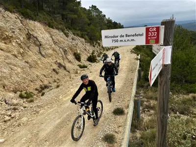 three people riding bikes on a dirt road at Casa de Madera I - Naturaleza y Experiencias in Bicorp
