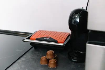 a room with a coffee maker and three brown cups at Modern Stay Near Benicalap Park in Valencia