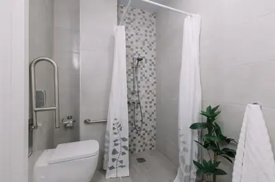 a white bathroom with a shower and a toilet at Modern Stay Near Benicalap Park in Valencia