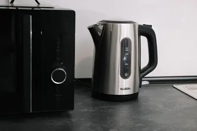 a coffee pot sitting on a counter next to a microwave at Modern Stay Near Benicalap Park in Valencia