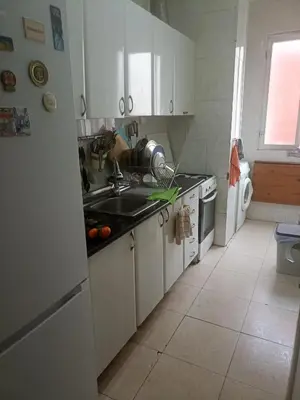 a kitchen with a sink and a stove and a refrigerator at Habitación Grande Ruzafa Centro in Valencia