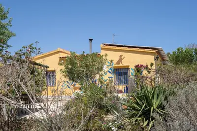 a yellow house with a mural on the side of it at Casa Rosa Longterm Living and Workspace in Monserrat