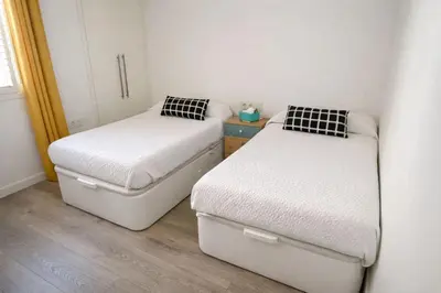 two beds in a small room at Terraced House MARIELISA in Puebla de Farnals