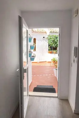 an open door to a room with a courtyard at Terraced House MARIELISA in Puebla de Farnals
