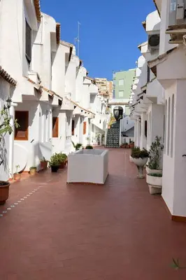 a courtyard of a building with white buildings at Terraced House MARIELISA in Puebla de Farnals