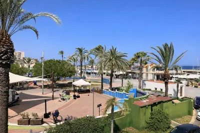 a park with palm trees and a playground at Terraced House MARIELISA in Puebla de Farnals