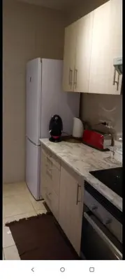a kitchen with white cabinets and a white refrigerator at Valencia city in Valencia