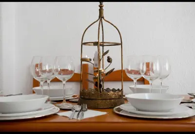 a table with plates and wine glasses and a chandelier at Valencia city in Valencia