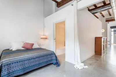 a bedroom with a bed in a white room at Casa Reina Nina in Valencia