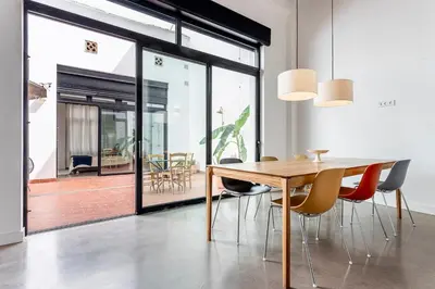 a dining room with a wooden table and chairs at Casa Reina Nina in Valencia