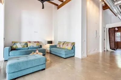 a living room with two blue couches and a couch at Casa Reina Nina in Valencia