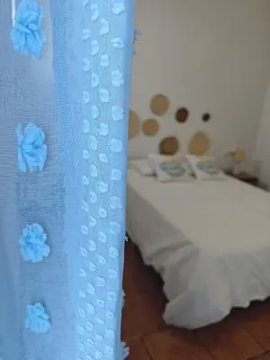 a bed with two pillows and a teddy bear at SeaSuites Blue - Casa cerca del mar en Cullera in Mareny de San Lorenzo