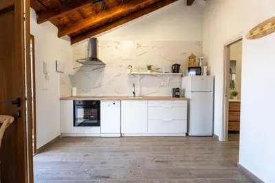 a kitchen with white appliances and a tile floor at Pinedo Playa Rustico in Valencia