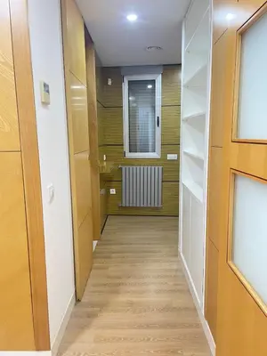 a hallway with wood floors and a window at Heart of Valencia in Valencia