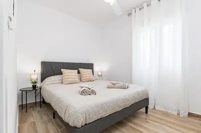 a bedroom with a bed with two pillows on it at Cielito Lindo Tu hogar temporal con encanto in Torrent