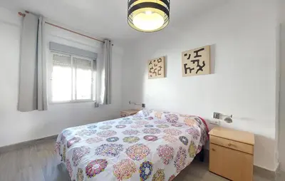a bedroom with a bed and a window at Lovely Apartment In Tavernes De La Valldig in Tavernes de Valldigna