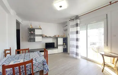 a kitchen and dining room with a table and a television at Lovely Apartment In Tavernes De La Valldig in Tavernes de Valldigna