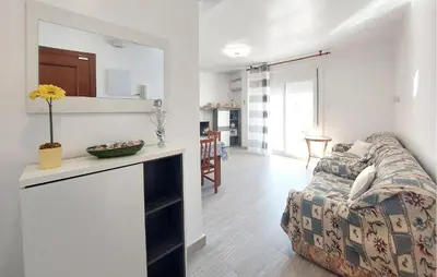 a living room with a couch and a kitchen at Lovely Apartment In Tavernes De La Valldig in Tavernes de Valldigna
