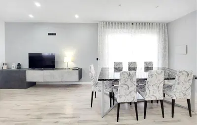 a dining room with a table and chairs and a tv at Awesome Home In Olocau in Olocau