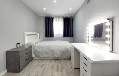 a bedroom with a bed and a dresser and a mirror at Awesome Home In Olocau in Olocau