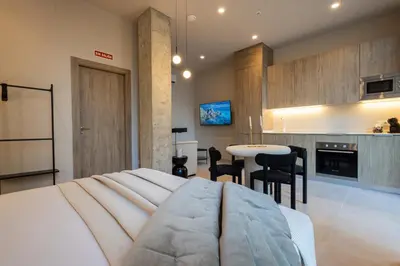 a bedroom with a bed and a kitchen with a table at Loft Valencia - B 1-6 Smart Access & Urban Calm in Valencia