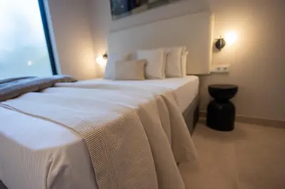 a bedroom with a large bed with white sheets and pillows at Loft Valencia - B 1-6 Smart Access & Urban Calm in Valencia