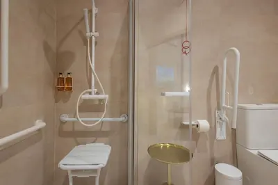 a bathroom with a shower with a toilet and a stool at Loft Valencia - B 1-6 Smart Access & Urban Calm in Valencia