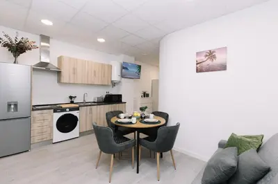 a kitchen and dining room with a table and chairs at N2 Bright & Comfortable Apartment Benicalap in Valencia
