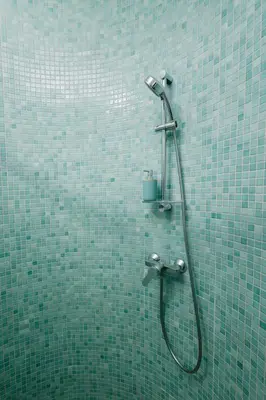 a shower in a bathroom with green tiles at N2 Bright & Comfortable Apartment Benicalap in Valencia