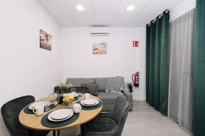 a living room with a table and a couch at N2 Bright & Comfortable Apartment Benicalap in Valencia
