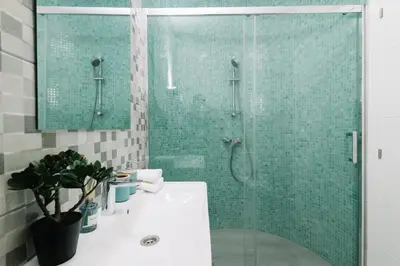 a bathroom with a glass shower and a sink at N3 Bright and Cosy apartament Park Benicalap N3 in Valencia