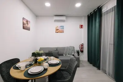 a living room with a table and a couch at N3 Bright and Cosy apartament Park Benicalap N3 in Valencia