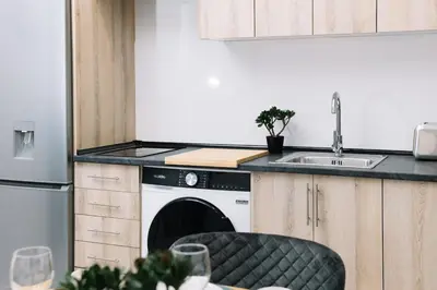 a kitchen with a white dishwasher next to a sink at N3 Bright and Cosy apartament Park Benicalap N3 in Valencia