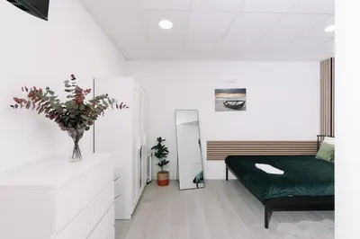 a room with a bed and a vase of flowers at N3 Bright and Cosy apartament Park Benicalap N3 in Valencia