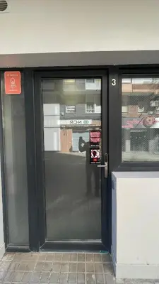 a door to a store with a sign on it at N3 Bright and Cosy apartament Park Benicalap N3 in Valencia