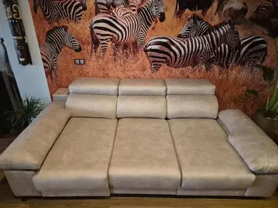a couch in a room with a mural of zebras at Acogedor y exótico hogar con piscina privada in Rafelguaraf