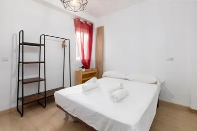 a bedroom with a white bed with two pillows on it at Modern 2BR in Beautiful Burriana in Burriana