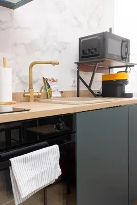 a kitchen counter with a sink and a microwave at Modern 2BR in Beautiful Burriana in Burriana