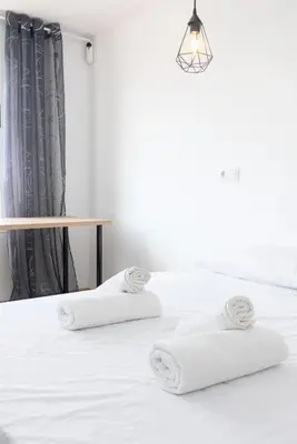 a white bed with two white towels on it at Modern 2BR in Beautiful Burriana in Burriana