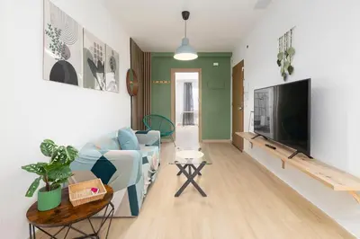 a living room with a blue couch and a flat screen tv at Modern 2BR in Beautiful Burriana in Burriana