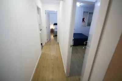 a hallway leading to a room with white walls and wood floors at Apartamento Ross - Central flat with all the amenities in Valencia