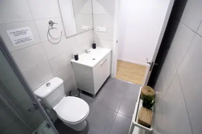 a white bathroom with a toilet and a sink at Apartamento Ross - Central flat with all the amenities in Valencia