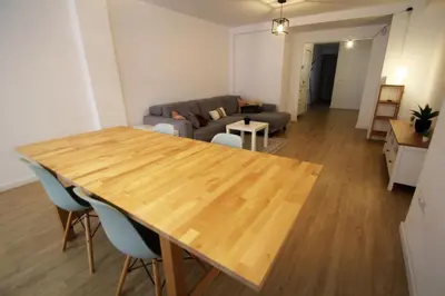 a living room with a wooden table and a couch at Apartamento Ross - Central flat with all the amenities in Valencia